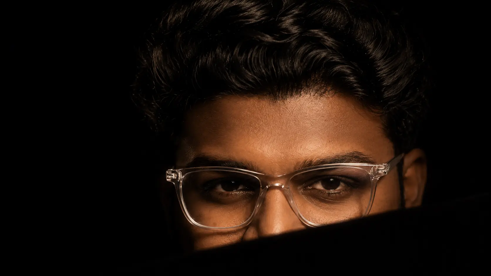 Nithish Reddy, AI search strategist in Hyderabad, in a low-key portrait wearing clear-framed glasses